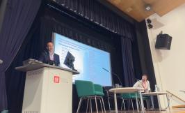 Woman presenting at podium at AFE Conference