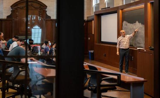 Ten UChicago faculty members were honored with Quantrell and Graduate Teaching Awards in recognition of their teaching and mentorship. Among the winners is Victor Lima, who is pictured teaching an economics course in Saieh Hall.